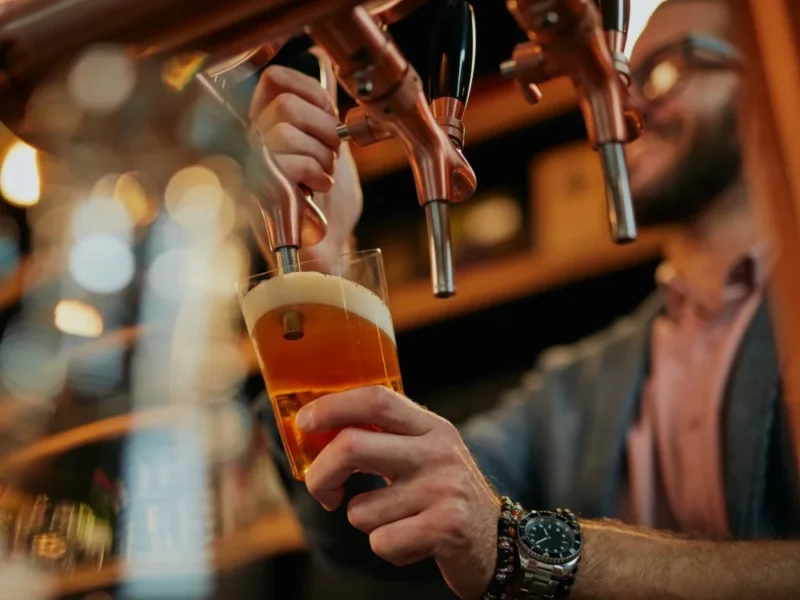 A man pulling a pint.