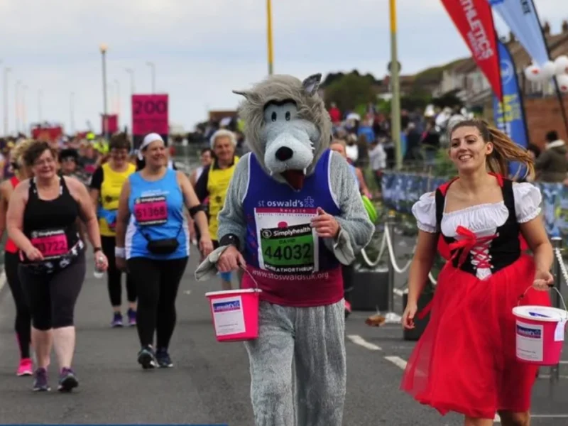 A man dressed as a wolf running a marathon