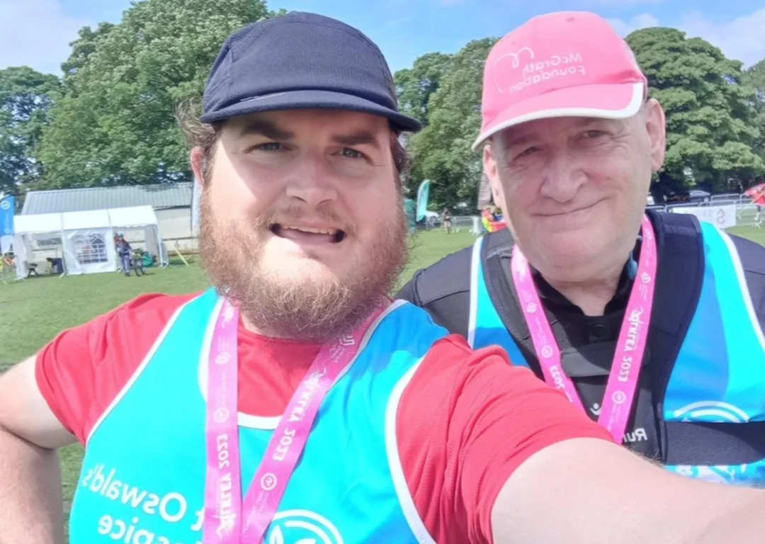 David and James Banks in marathon gear smiling with medals.