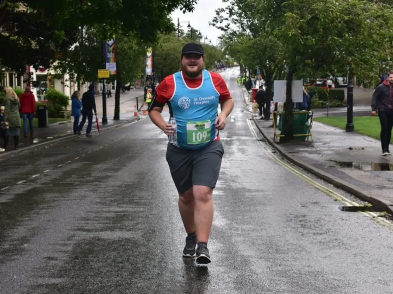 James Banks running on a rural road in marathon gear.