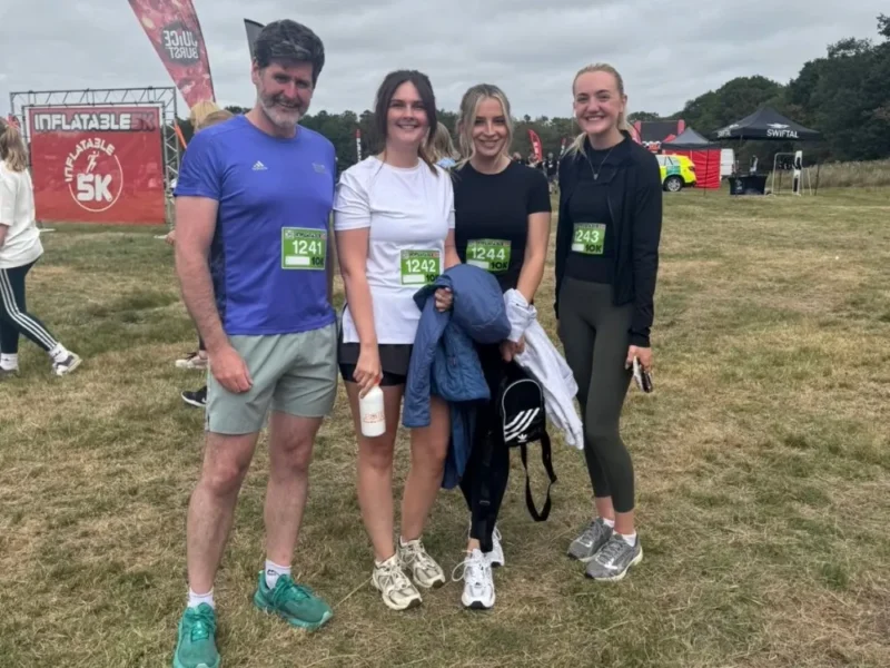 A group of charity runners standing in a line.