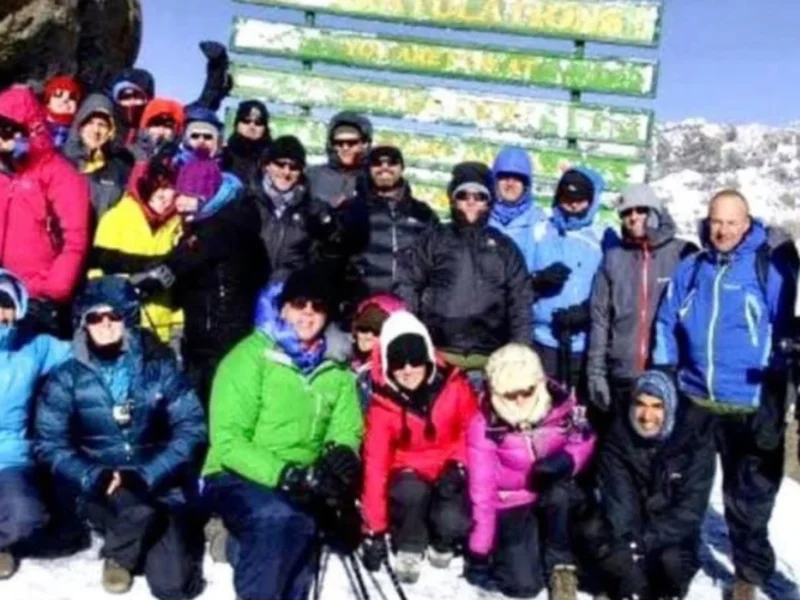 A group of people in warm clothing on a mountain.
