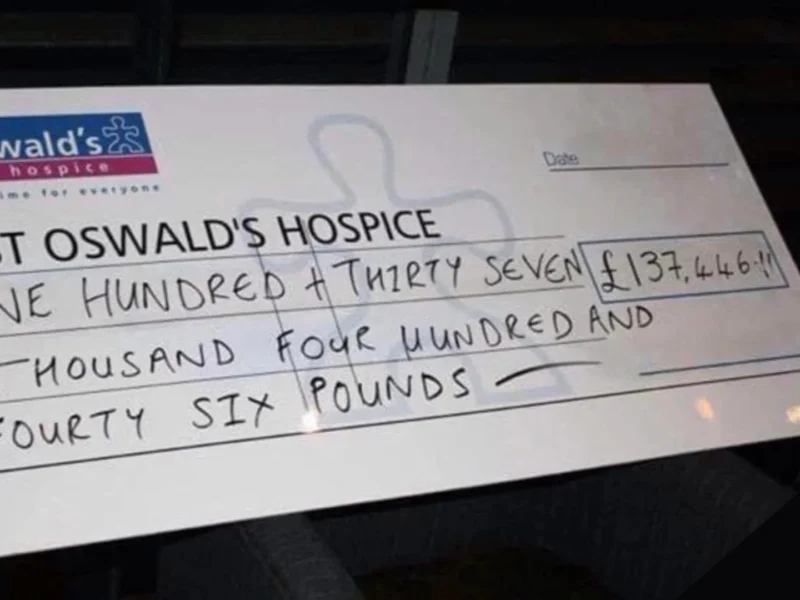 A large cheque for St Oswald's Hospice with £137,000 on it.