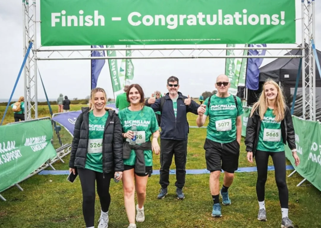 David Banks and other fundraisers cross the line at the Macmillan Half Marathon Hike.